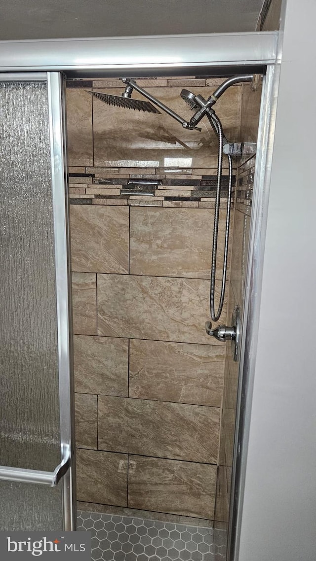 bathroom with tiled shower