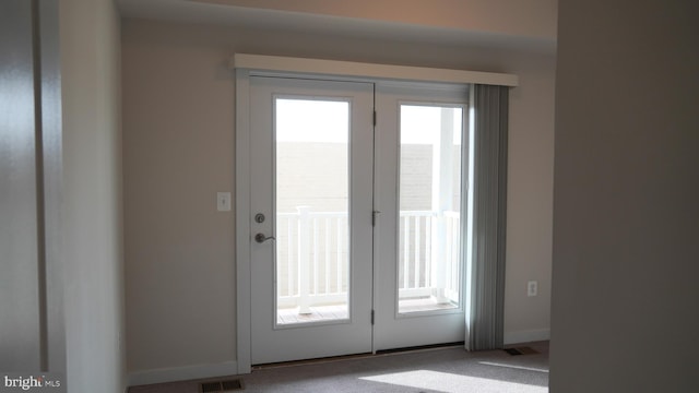 doorway with light carpet