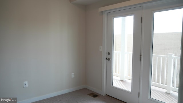 doorway featuring carpet