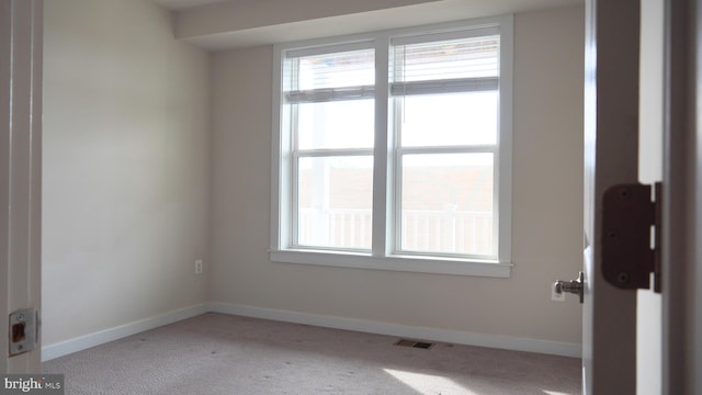 unfurnished room featuring light colored carpet