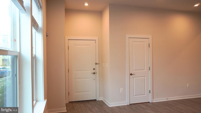 hallway featuring wine cooler, a wealth of natural light, and dark hardwood / wood-style flooring