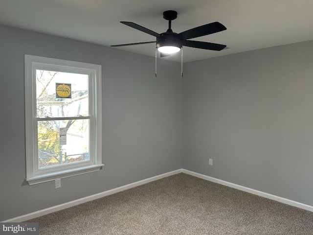 empty room featuring ceiling fan and carpet floors