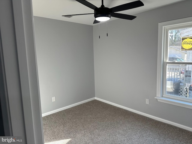 carpeted spare room with ceiling fan