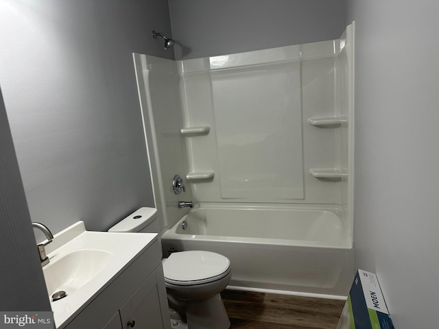 full bathroom with bathing tub / shower combination, vanity, wood-type flooring, and toilet