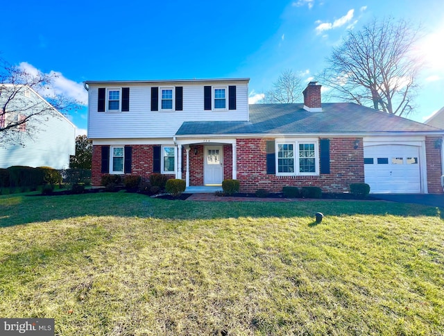 view of property featuring a front yard and a garage