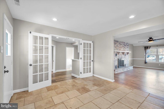 unfurnished living room with french doors and ceiling fan