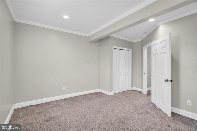 unfurnished bedroom featuring a closet, carpet floors, and crown molding