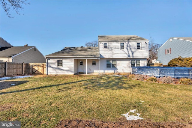 back of property featuring a covered pool, a yard, and a patio area