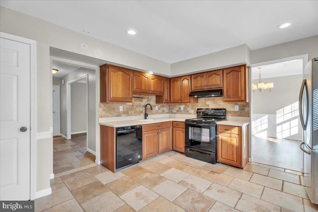 kitchen with sink, decorative light fixtures, tasteful backsplash, black appliances, and a notable chandelier