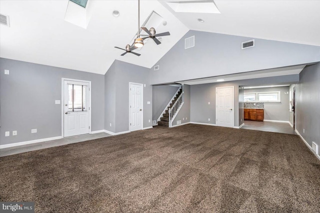 unfurnished living room with carpet, ceiling fan, high vaulted ceiling, and a skylight