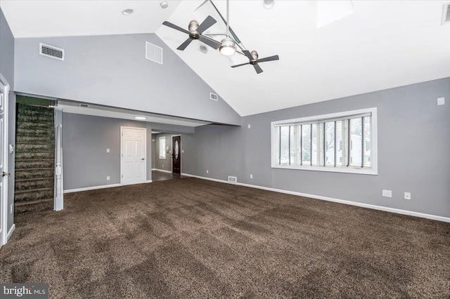 unfurnished living room with carpet, high vaulted ceiling, and ceiling fan