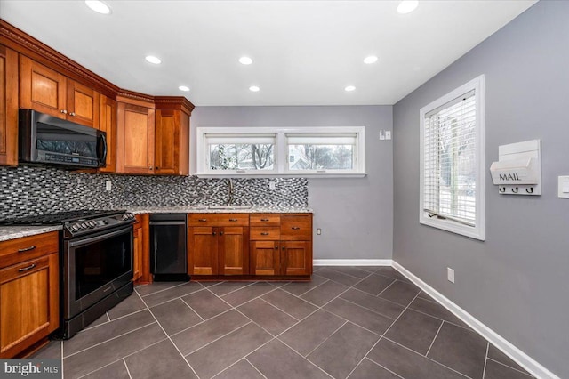 kitchen with a healthy amount of sunlight, backsplash, black range oven, and sink