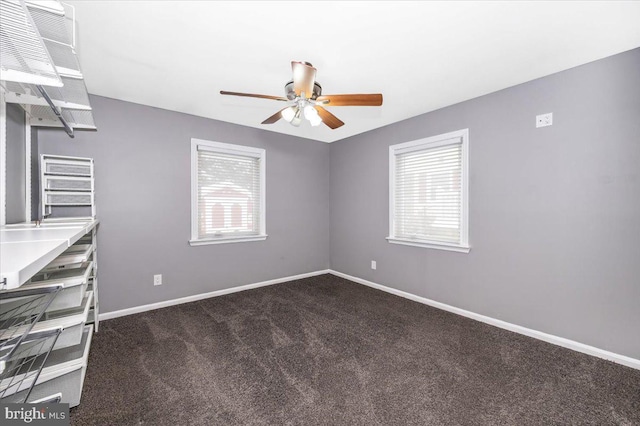 carpeted empty room with plenty of natural light and ceiling fan