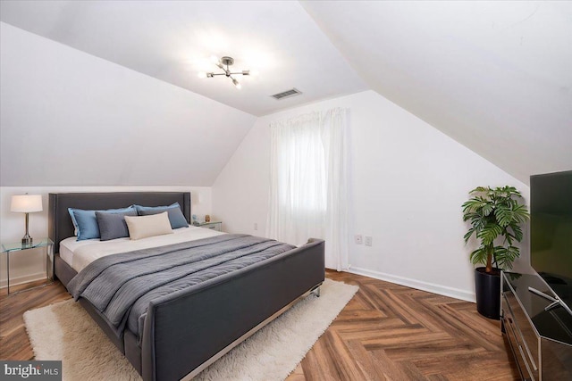 bedroom featuring dark parquet floors and vaulted ceiling