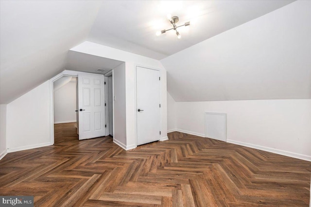 bonus room featuring dark parquet flooring and lofted ceiling