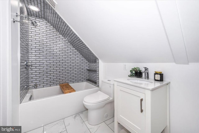 full bathroom featuring vanity, toilet, tiled shower / bath, and lofted ceiling