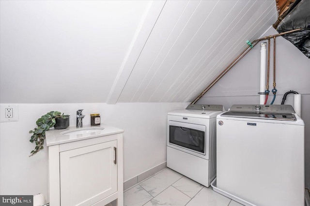 laundry area featuring sink, cabinets, and independent washer and dryer