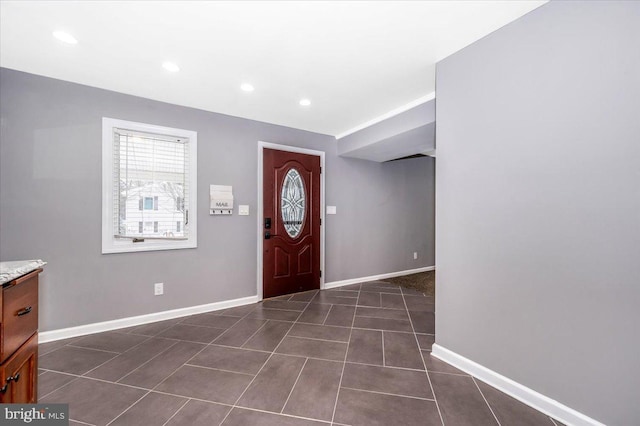 entrance foyer featuring dark tile patterned floors