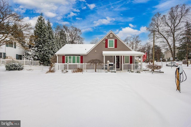 snow covered house with covered porch