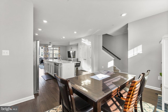 dining room with ceiling fan, dark hardwood / wood-style flooring, and sink