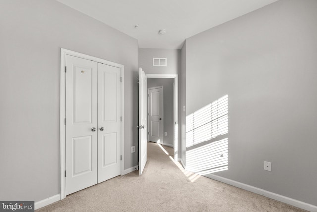 corridor with light colored carpet