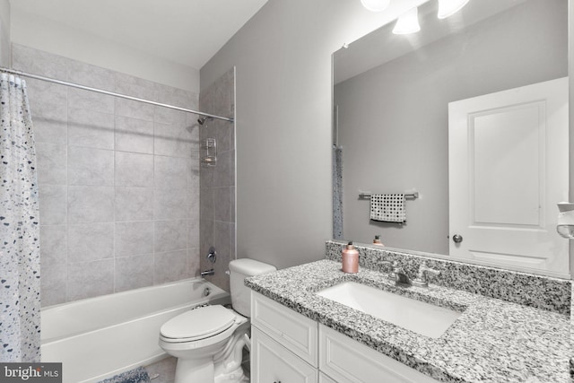 full bathroom with shower / tub combo with curtain, vanity, and toilet