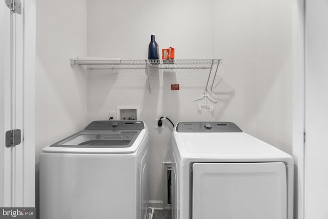 clothes washing area featuring washer and clothes dryer