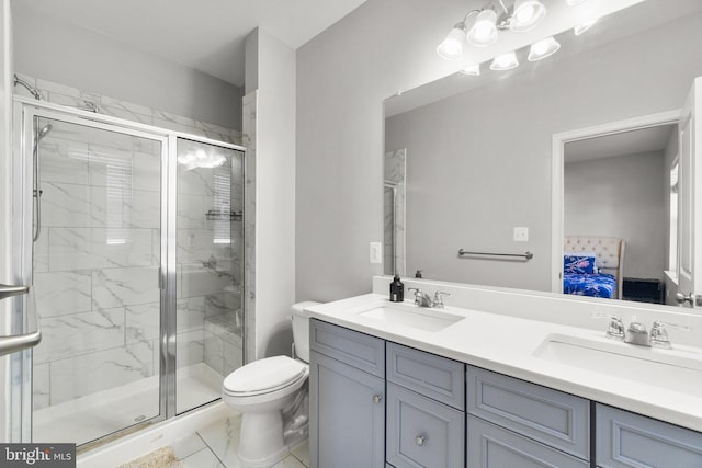 bathroom with toilet, a shower with door, and vanity