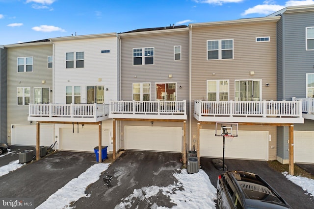 snow covered property featuring a balcony and central air condition unit