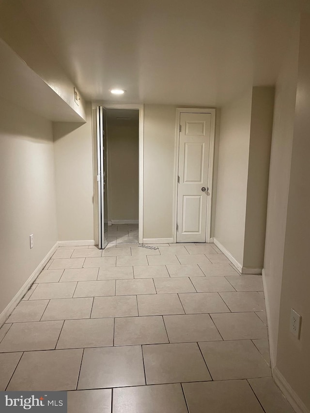 basement with light tile patterned flooring