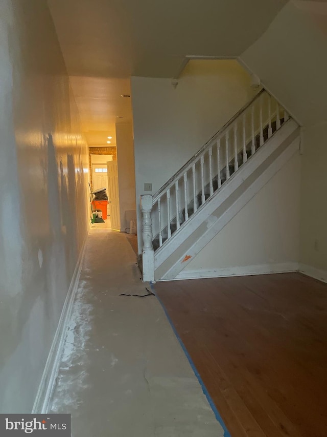 stairway with concrete flooring