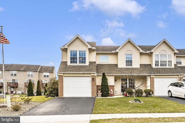 view of front of home with a garage and a front lawn