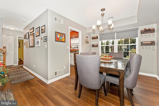 dining space with an inviting chandelier and wood-type flooring