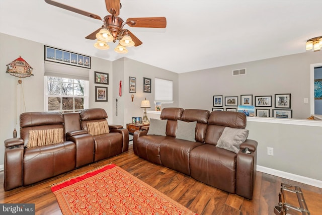 living room featuring hardwood / wood-style floors and ceiling fan