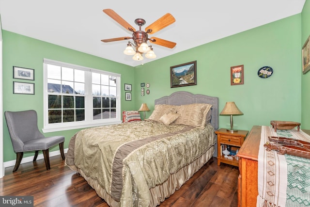 bedroom featuring ceiling fan and dark hardwood / wood-style floors