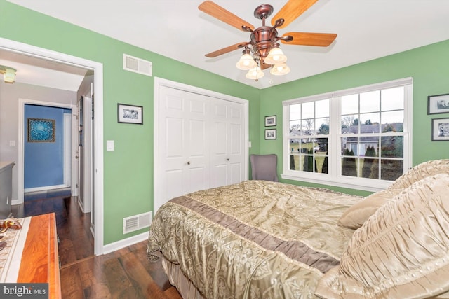 bedroom featuring dark hardwood / wood-style flooring, a closet, and ceiling fan