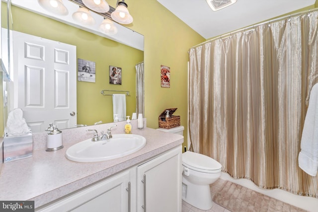 bathroom featuring tile patterned flooring, vanity, curtained shower, and toilet