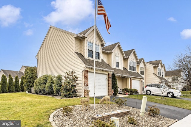 view of front of home featuring a garage and a front yard