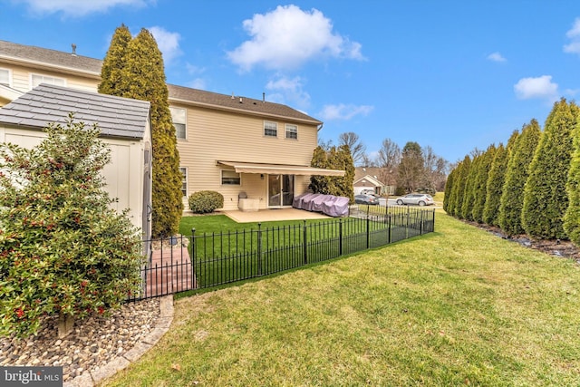 back of house with a lawn and a patio area