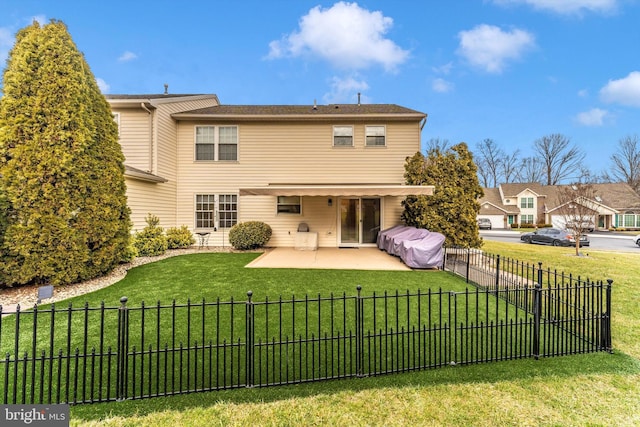 back of property featuring a yard and a patio