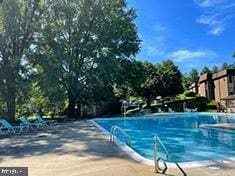 view of swimming pool with a patio