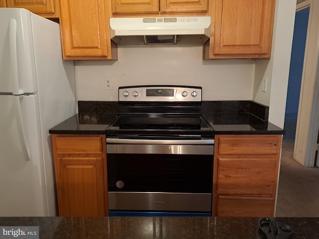 kitchen featuring white fridge, stainless steel electric range oven, and dark stone counters