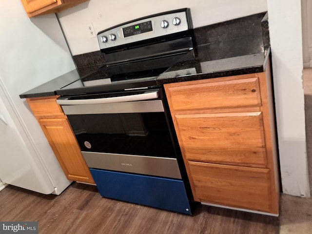 kitchen featuring dark wood-type flooring and stainless steel electric range