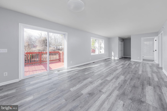 unfurnished living room with light wood-type flooring