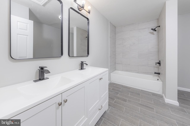 bathroom featuring vanity and tiled shower / bath