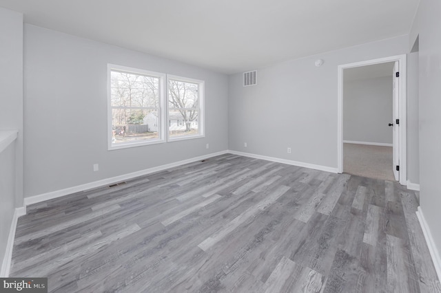 unfurnished room with light wood-type flooring