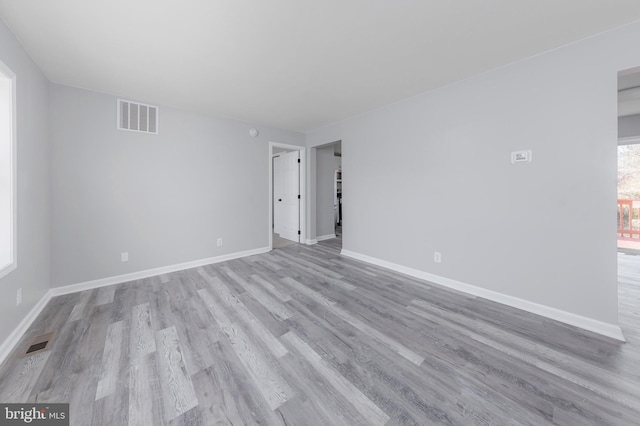 spare room with light hardwood / wood-style flooring