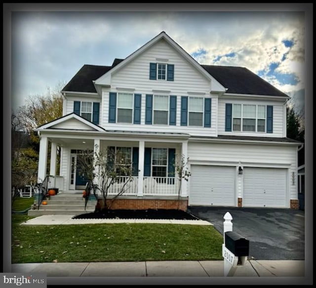 view of property featuring a front lawn, a porch, and a garage