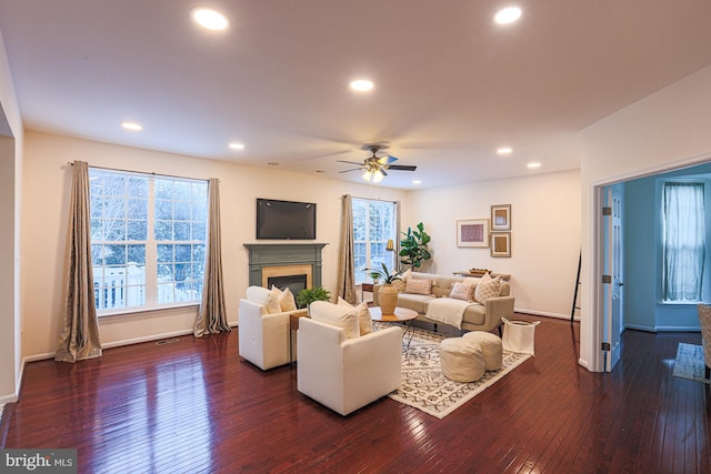 living room with ceiling fan and dark hardwood / wood-style floors