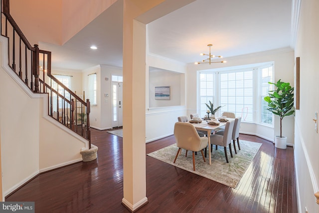 dining room featuring ornamental molding, dark hardwood / wood-style flooring, and a notable chandelier